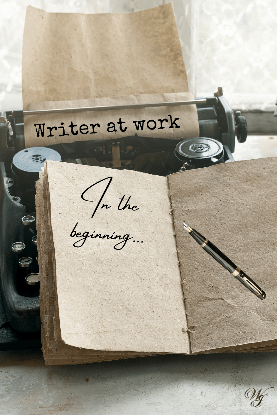 Vintage typewriter with a sheet of paper reading "Writer at work," next to an open journal that says "In the beginning…" with a black and gold pen resting on the page.